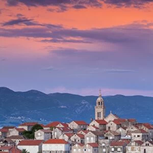 Elevated view over picturesque Korcula Town illuminated at sunset, Korcula, Dalmatia