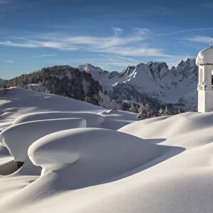 The huts and the bell tower at Alpe Scima covered in snow. Alpe Scima, valchiavenna