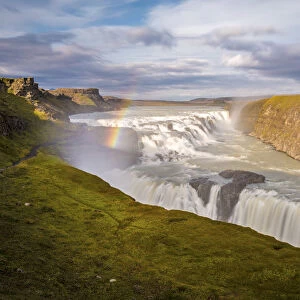 Iceland, Gullfoss at sunset, rainbow and water steam, icelandic landscape