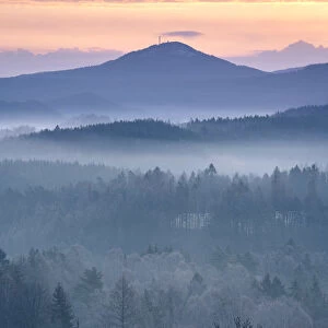 Jedlova mountain in Lusatian mountains rising above fog taken from Krizovy vrch hill at