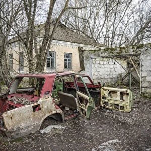 Lada car and house in an Abandoned village inside the Chernobyl Exclusion Zone, Ukraine