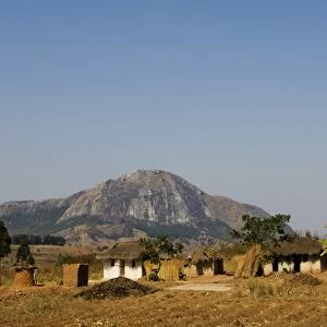 Malawi, Dedza. Grass-roofed houses in a rural village in the Dedza region