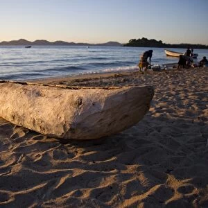 Malawi, Monkey Bay. An old dug-out canoe pulled up on to the beach of Lake Malawi