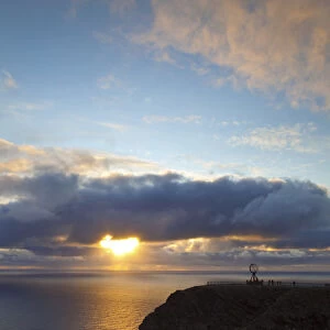 The Midnight Sun breaks through the clouds at Nordkapp, Finnmark, Norway