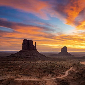 The Mittens against colourful cloudy sky at sunrise, Monument Valley, Arizona, USA
