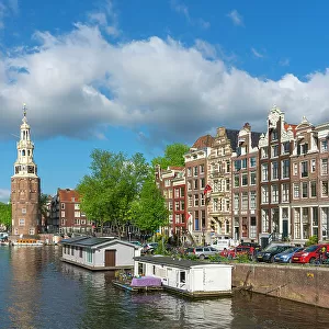 Montelbaanstoren tower by Oudeschans canal against sky, Amsterdam, North Holland, Netherlands