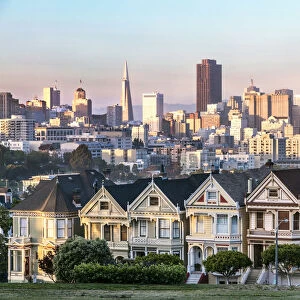 Painted ladies and skyline at sunset, San Francisco, California, USA