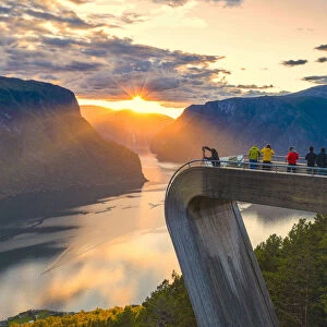People photographing sunset on the fjord from Stegastein viewpoint, aerial view