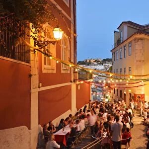 A restaurant in the Calcada do Duque, with a view to the Sao Jorge castle at twilight