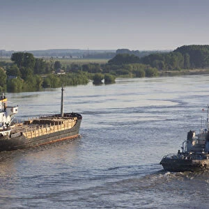 Romania, Danube River Delta, Tulcea, elevated view of freighter on the Danube River, dawn