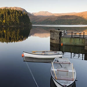Rowing boats moored on Loch Katrine at Stronachlachar, Stirling, Scotland. Autumn