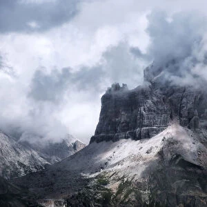 Rugged peaks partly covered in clouds, Dolomites, Italy