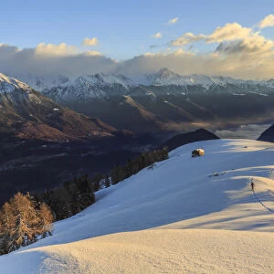 Ski mountaineer on Monte Olano at sunrise, Gerola Valley, Sondrio province, Valtellina