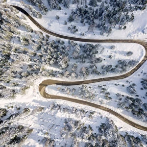 Snowy road aerial view, Passo Delle Erbe, Funes Valley, South Tyrol, Italy