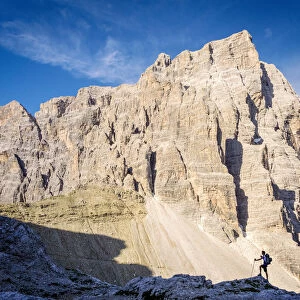 South Tyrol, Sexten, Bolzano. Hiker in silhouette in front of the north east wall