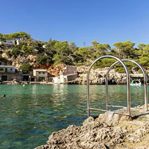 Stairs lead into the ocean at a cove (Cala) in Mallorca, Spain