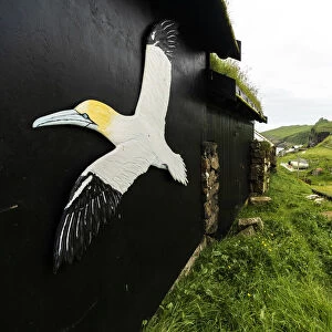 Symbol of Northern Gannet seabird on outside walls of house, Mykines island, Faroe