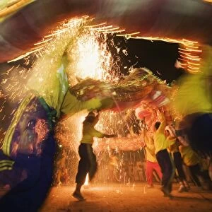 Thailand, Ko Phuket, Phuket. Dragon dancers and fireworks during the Phuket Vegetarian Festival