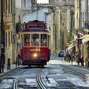 A tramway in Alfama district with the Motherchurch (Se Catedral) in the background