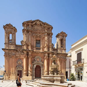 Trapani, Sicily. A woman walking in front of Purgatory Church in Marsala town center