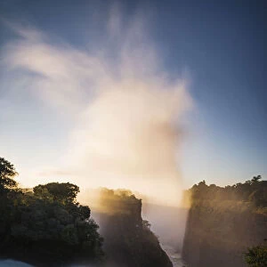 The Victoria Falls depicted at sunrise from Devils Cataract, in Zimbabwe side