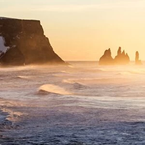 Vik, Southern Iceland, Europe. The rock formations of Reynisdrangar and ocean waves