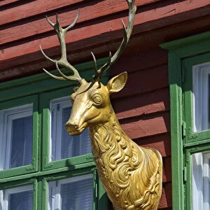 Wooden statue of a deer on a house facade