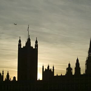 A plane flying over the Houses of Parliament London UK
