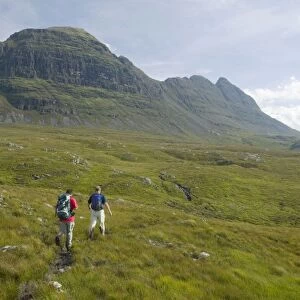 Walkers approaching Suilven mountain in Sutherland Scotland UK