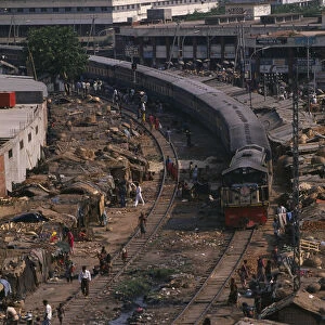 BANGLADESH, Dhaka Train travelling through Tejgoan slum with ramshackle dwellings