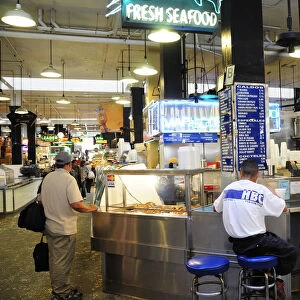 Central Market scene with people sat around a seafood bar