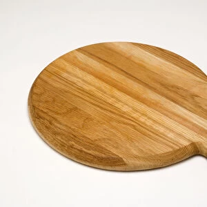 Food, Cooking, Preparation, Circular wooden pizza board with a handle on a white