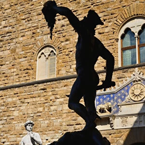 Italy, Tuscany, Florence, Piazza della Signoria, Replica of the famous David statue by Michelangelo with silhouette of the Perseus statue