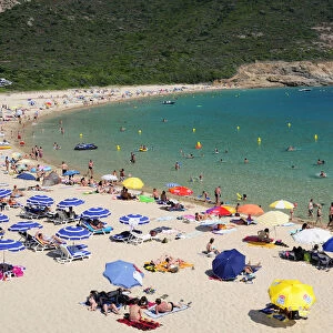 Plage Darone sandy beach with umbrellas & bathers & clear water