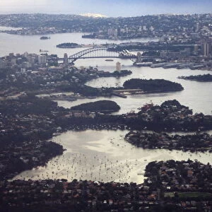 Aerial picture shows Sydney Harbour Bridge and Central Business District behind houses