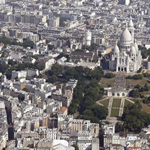 An aerial view shows the Sacre Coeur Basilica and rooftops of residential buildings