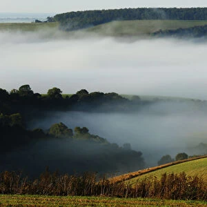 Autumn mists hang over villages and the countryside in the South Downs National Park