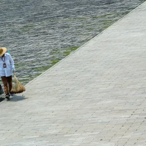 A CLEANER WALKS THROUGH THE FORBIDDEN CITY IN BEIJING