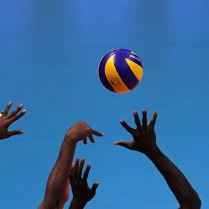 Cubas players try to block the ball during their match against Italy in the Volleyball