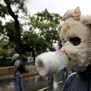 A demonstrator wears a homemade gas mask while rallying against Venezuelas President