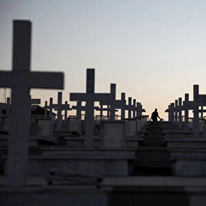 A man walks past the graves of soldiers killed in the 1974 Turkish invasion of Cyprus at