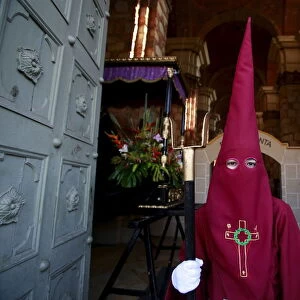A member of the Nazarenos brotherhood takes part in a processsion on Good Friday in