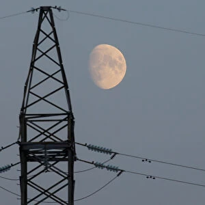 The moon rises behind a power line near the Chernobyl Nuclear Power Plant in Chernobyl