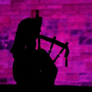 A piper plays a tune at Edinburgh Castle to herald the New Year during the Hogmanay