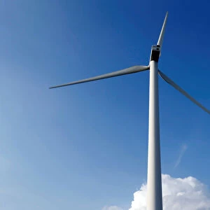 A power-generating wind turbine is seen near the city of Mouchamps