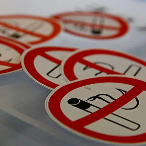 No smoking signs are seen on a table in the Karas printing shop in Vienna