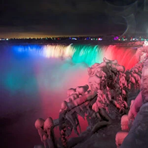 Visitors take pictures of ice covered Niagara Falls in Niagara