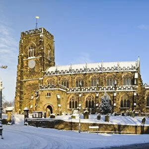 15th century church in snow on sunny day, St. Marys Church, Thirsk, North Yorkshire, England, January