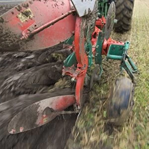 Close-up of four furrow reversible plough, ploughing stubble field, Sweden