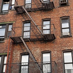 Fire escape ladders on side of brick apartment buildings, New York City, New York State, U. S. A. september